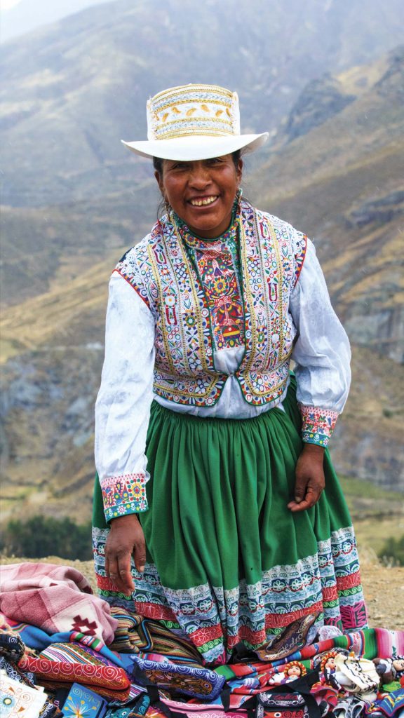 Woman wearing traditional attire from Puno region, Peru - Cultural dress with vibrant colors.