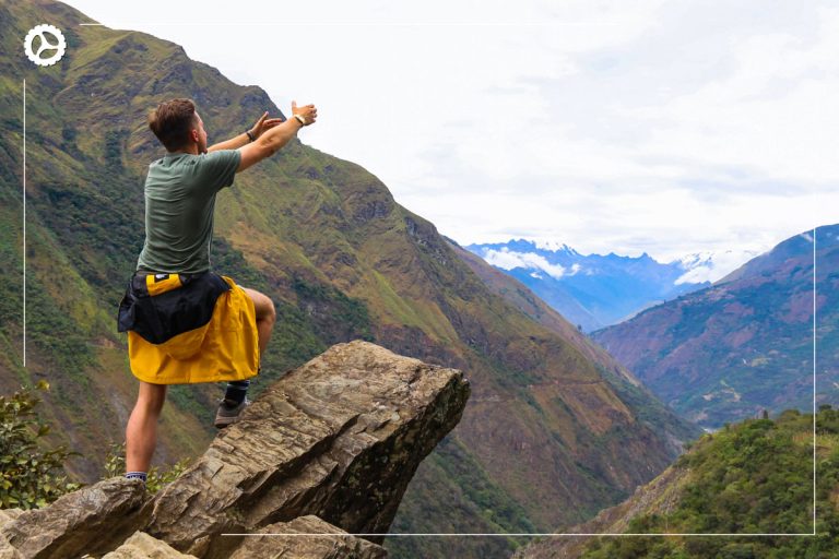 Hiker atop a ledge amidst breathtaking views