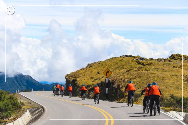 Tourists descending the Málaga Pass by bike on the Inca Jungle Basic tour