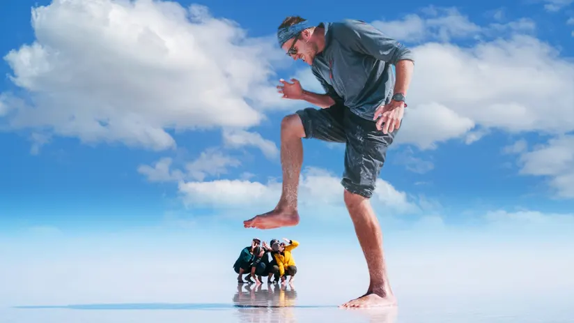 Salar de Uyuni perspective trick Forced-perspective photo at Salar de Uyuni, Capital de Bolivia: “giant” man and tiny group reflected on salt flats.