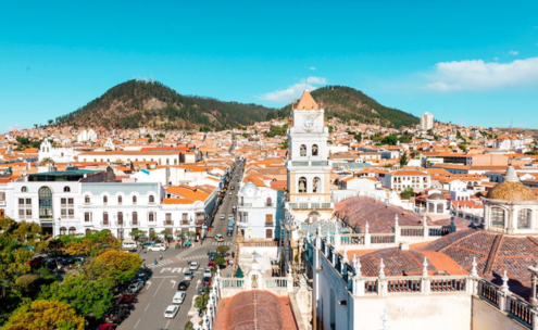 Sucre historic center, Bolivia Colonial Sucre, Bolivia, with white facades, cathedral tower, and red-tile roofs.