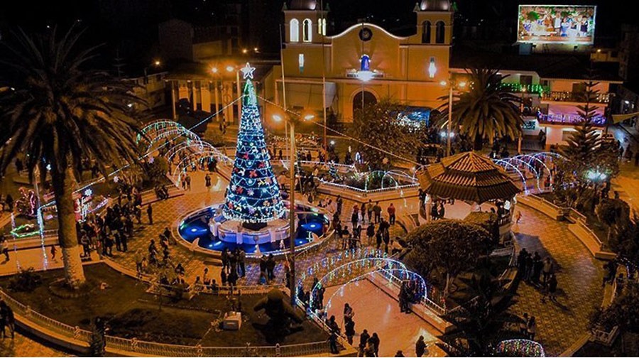 Peruvian town square at night with Christmas lights