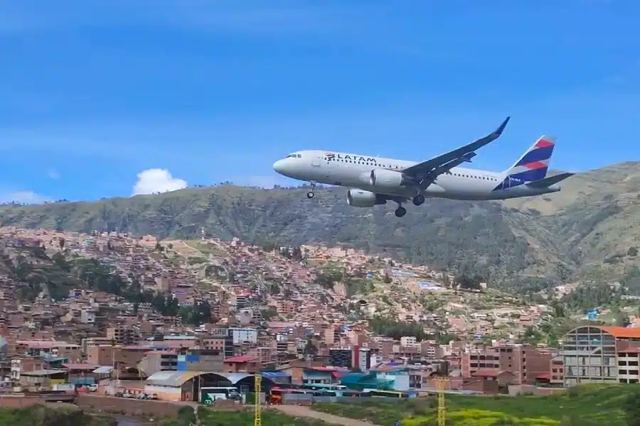 Cusco Airport: Complete Guide for Travelers 2 Airplane landing at Cusco airport surrounded by mountains.