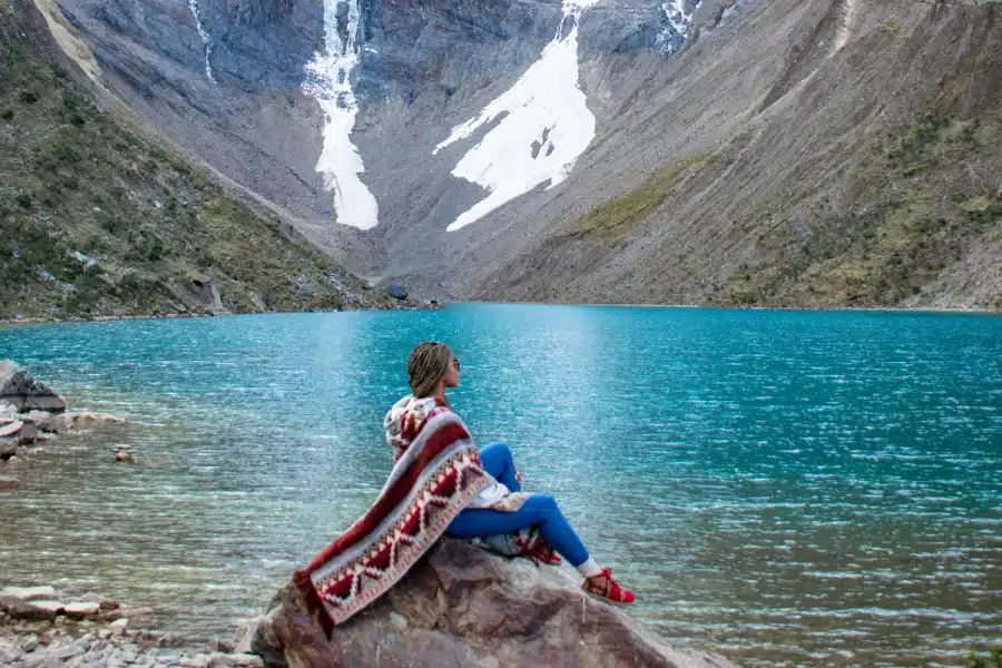 Humantay Lake Difficulty: How Hard Is This Stunning Hike? 1 hiker resting at Humantay Lake showing hike difficulty