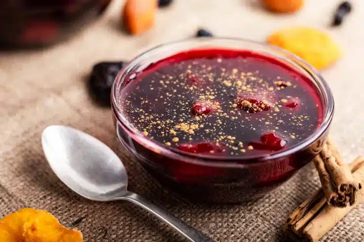 Postres Peruanos Tradicionales que debes probar 2 Mazamorra morada made with purple corn, fruits, and spices.