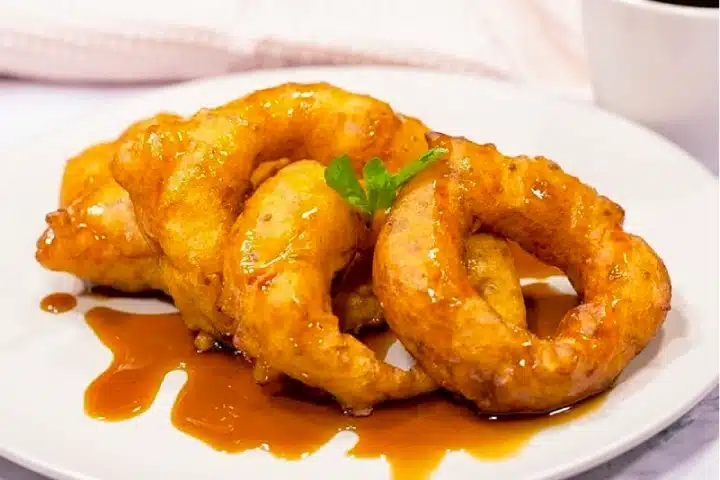 Postres Peruanos Tradicionales que debes probar 4 Freshly made Peruvian picarones served with sweet chancaca syrup.