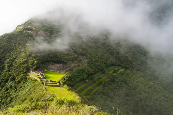 Choquequirao Trek: Distance, Difficulty, Cost, and Itinerary Guide for 2026 6 Choquequirao archaeological site surrounded by clouds in the Andes.