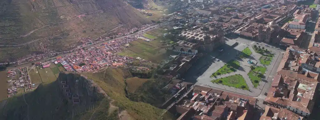 Aerial comparison of the Sacred Valley vs Cusco showing their distinct landscapes and urban environments.