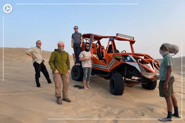 Paracas, Ballestas Islands, Huacachina & Nazca: The Perfect 2-Day Peru Itinerary 1 Travelers posing beside a dune buggy in Huacachina, Peru