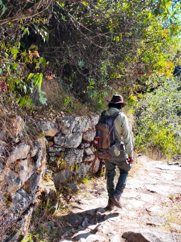 How Difficult Is the Inca Trail? Complete Difficulty Guide (Classic vs Short Trail) 6 Hiker walking along a stone pathway on the Inca Trail
