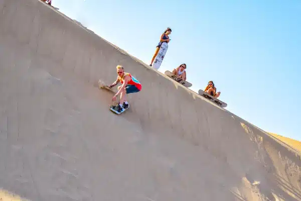 Huacachina Peru: Complete Travel Guide to the Desert Oasis 2 Sandboarding on the Huacachina desert dunes