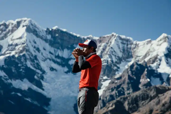 Salkantay Mountain: History, Meaning and Spiritual Significance 2 Traveler enjoying the spectacular mountain scenery of the Peruvian Andes.